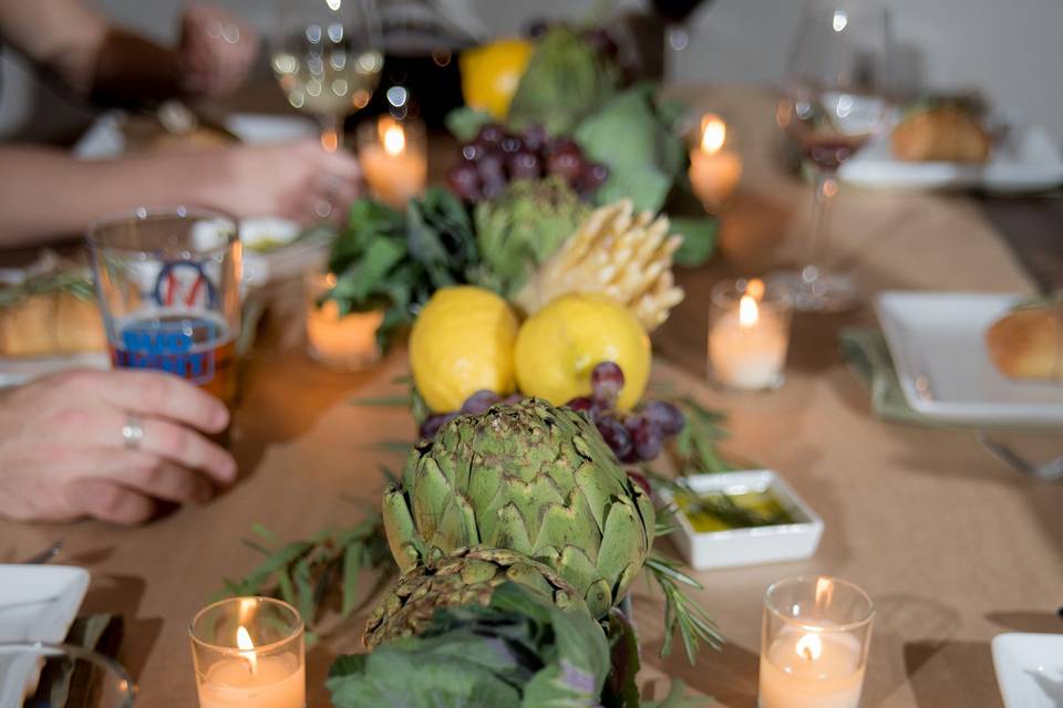 Dining table setup with Fruits and vegetable on the middle