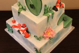 A serene pond  swimming with custom created fondant koi and peacefully blooming gum paste lotus flowers.