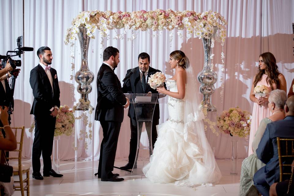 An unuasual arch crafted with vases and flowers