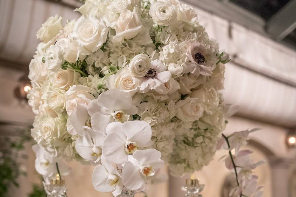 Rose, Hydrangea and Orchid blooms compliment the crystal candelabra