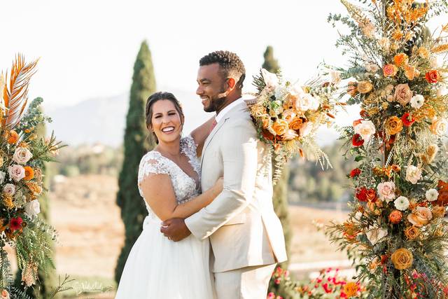 Bride and Groom in floral arch