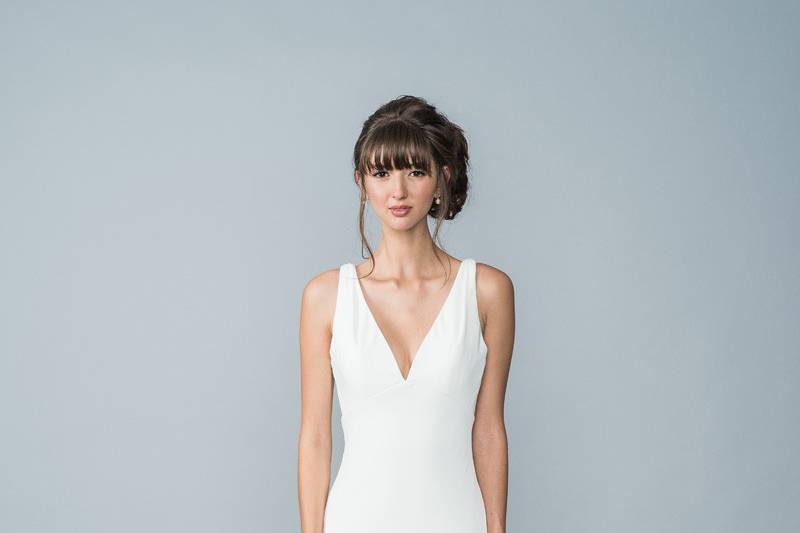 Style Hilton <br> A satin-jersey, corded lace gown that is fit and flare. Has an illusion lace back with beautiful eye-catching pearl buttons.
