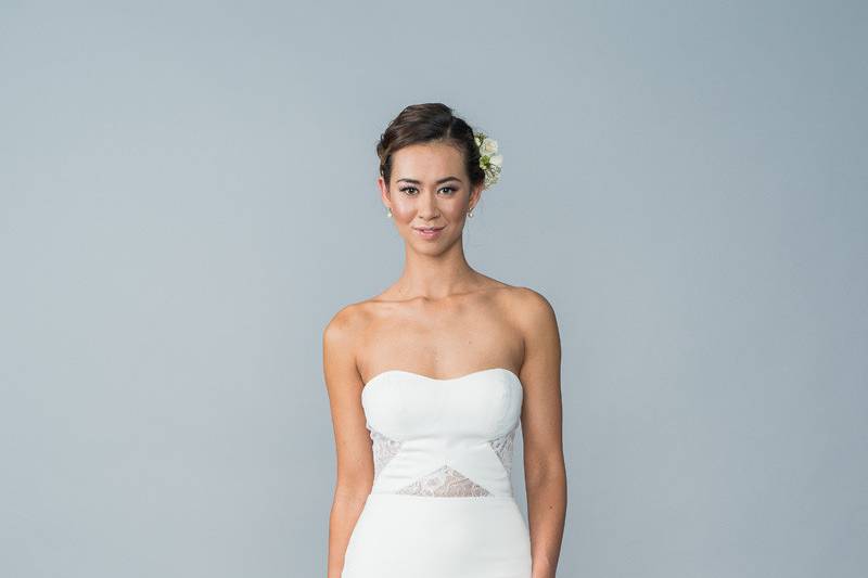 Style Holly <br> A satin-jersey and soft lace gown that has a soft sweetheart neckline. Beautiful statement lace cut-outs on side and front of bodice. Finished with an illusion lace back with boning, pearl buttons and zipper back.