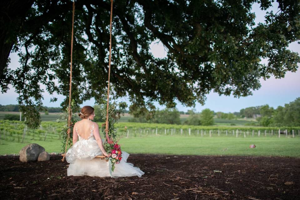 Bride twirling in meadow