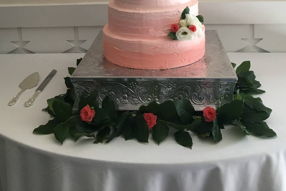 Pink gradient wedding cake with flowers
