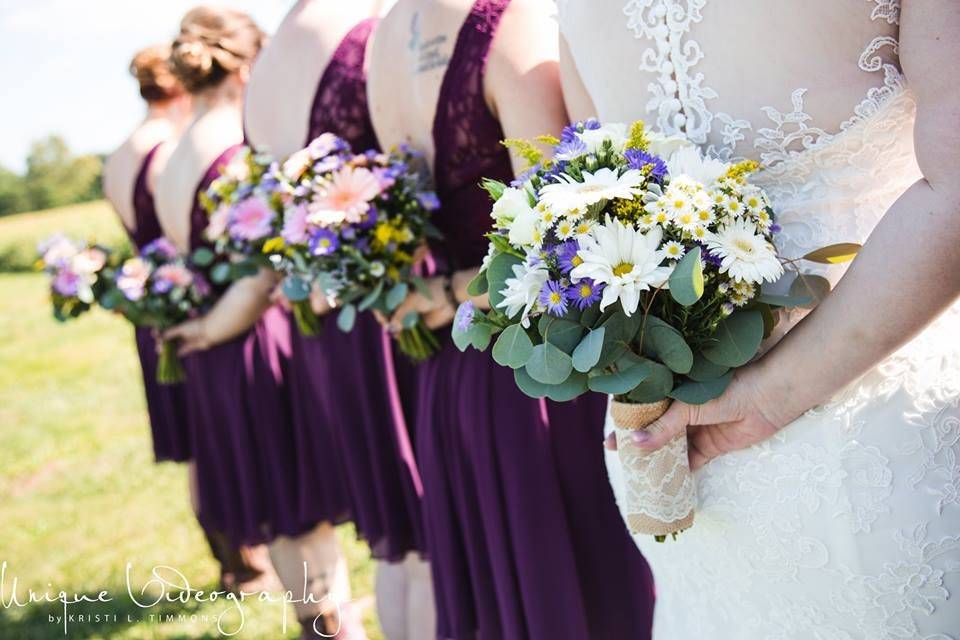 The bride with her bridesmaids holding their bouquet