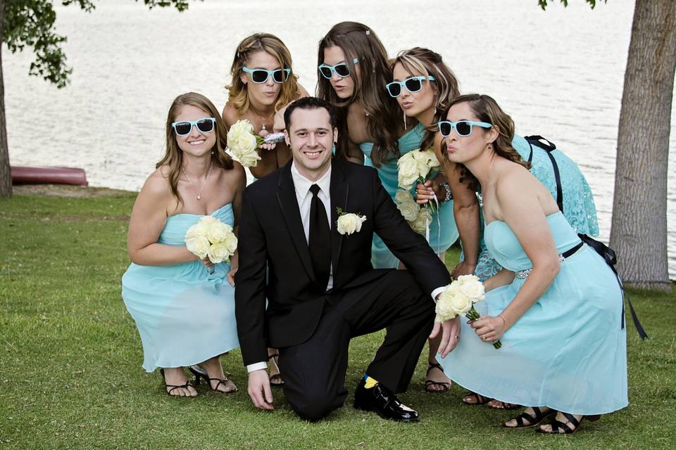 Groom poses with the bridesmaids.
