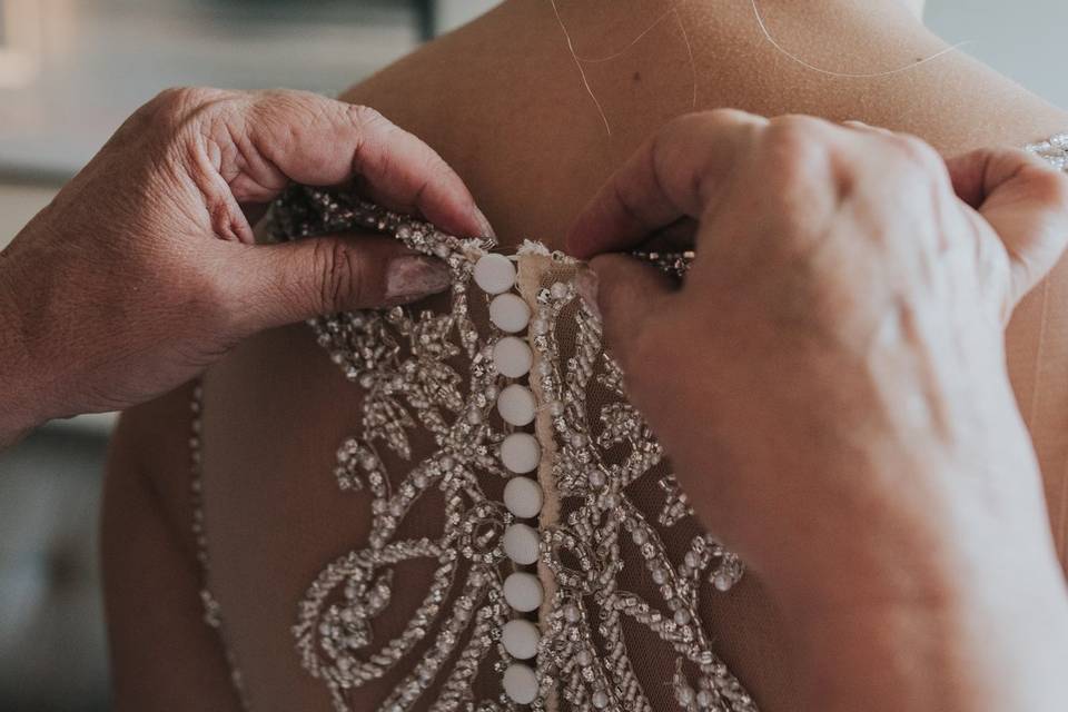 Buttoning up the wedding dress