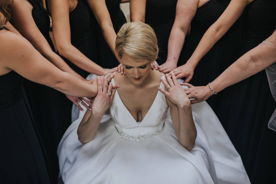 Praying with her bridal party