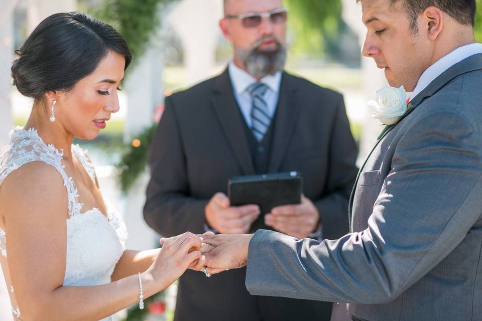 Bride putting ring on husband