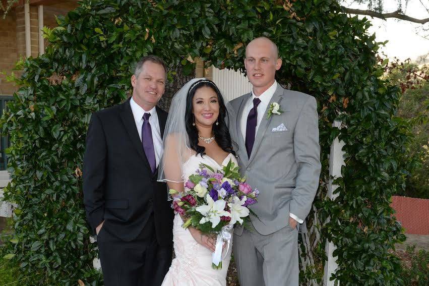 Officiant photo with newly wed couple
