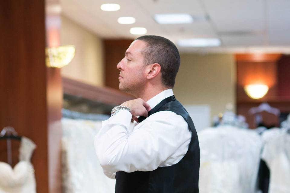 The groom trying on suits