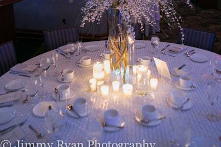 Table setting with tall floral and candle centerpiece