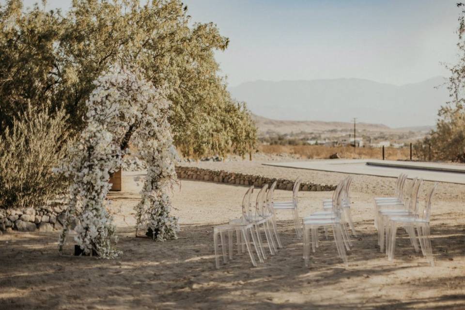 White arch and chairs