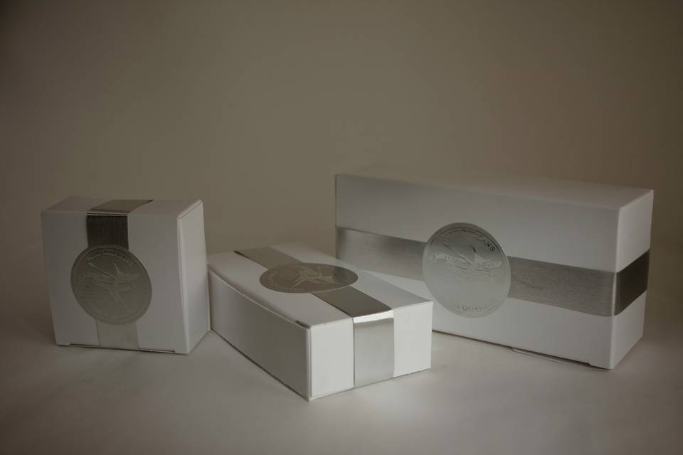 One, two, and four piece favor boxes with silver seal and silver ribbon. Your choice of pralines, tortues, or toffee in each one. Custom seals available.