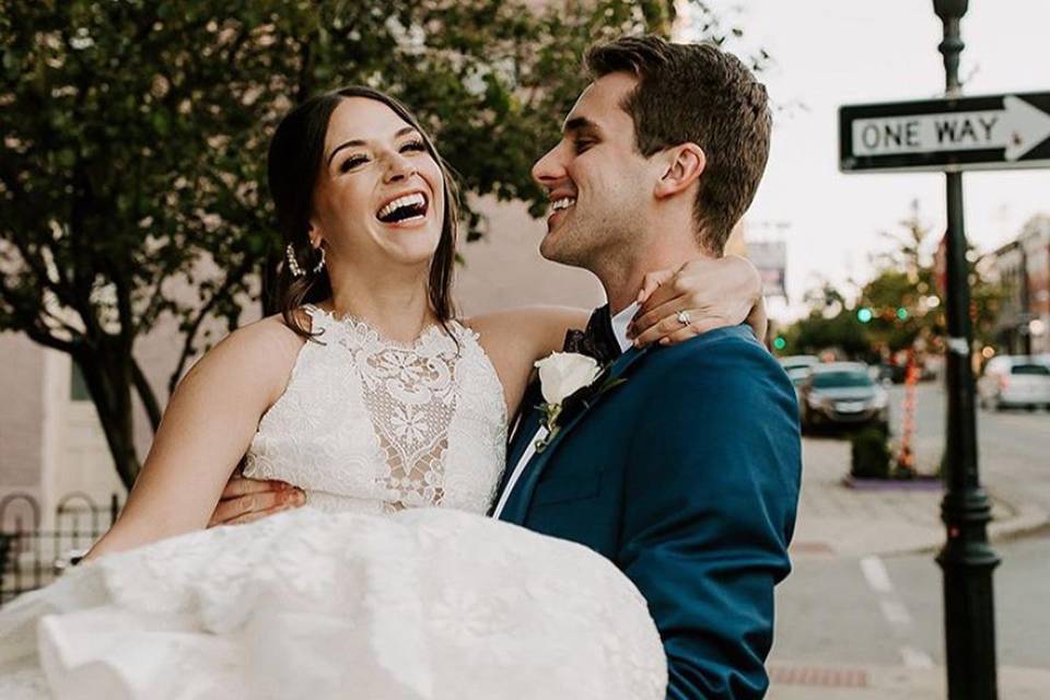 Groom carrying his bride