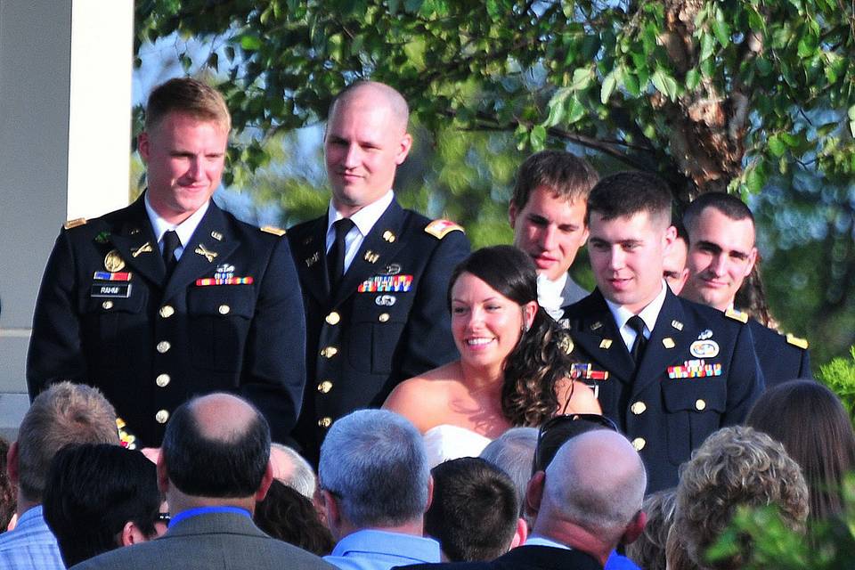 Groom and his groomsmen behind the bride