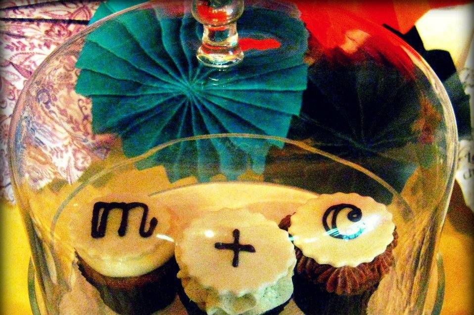 Custom cupcake toppers piped in chocolate inspired by the Bride & Grooms signature monogram