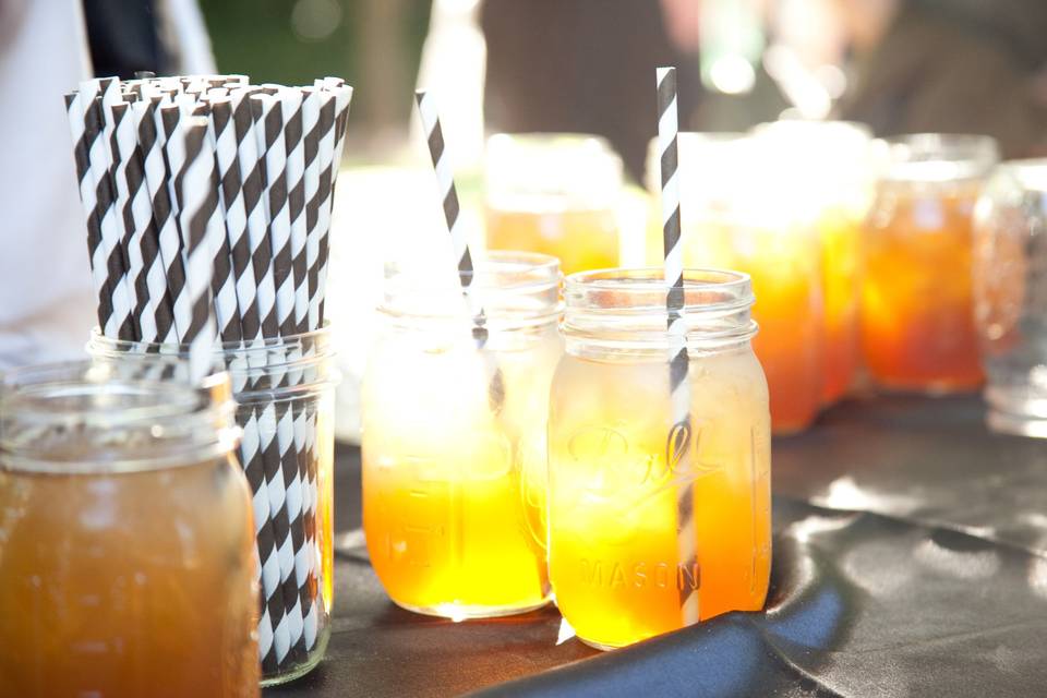 Signature Drinks in mason jars with a stripped straw
