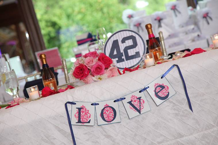 WEDDING ESCORT CARDS
THE TABLE TENT Escort Cards (View from Mike & Kelly’s Big Day)
Our Tent style Escort Cards like you’ve seen before…sort of. Most times this style Escort Cards comes on white paper with pre-formatted simple text. Not this. We design them inside and out. Imagine the outside front with a monogram and on the other side a spot for your guest’s name and table. The inside is where it gets fun. We can place some fun facts about your wedding, fun questions to ask about the Bride and Groom, fun facts about something regarding your theme or even photos of you and yours. This tent style Escort Cards will be a big help for the table of guests that may not know each other very well to start the conversation going!
THE LOVE TICKET Escort Cards (View from Joey & Maria’s Big Day)
Sized at 2″ x 8″ this style Escort Card becomes a quick hit as soon as guests enter Cocktail Hour. The ability to have up to 4 different designs lets you showcase photos of you and your partner. If you g