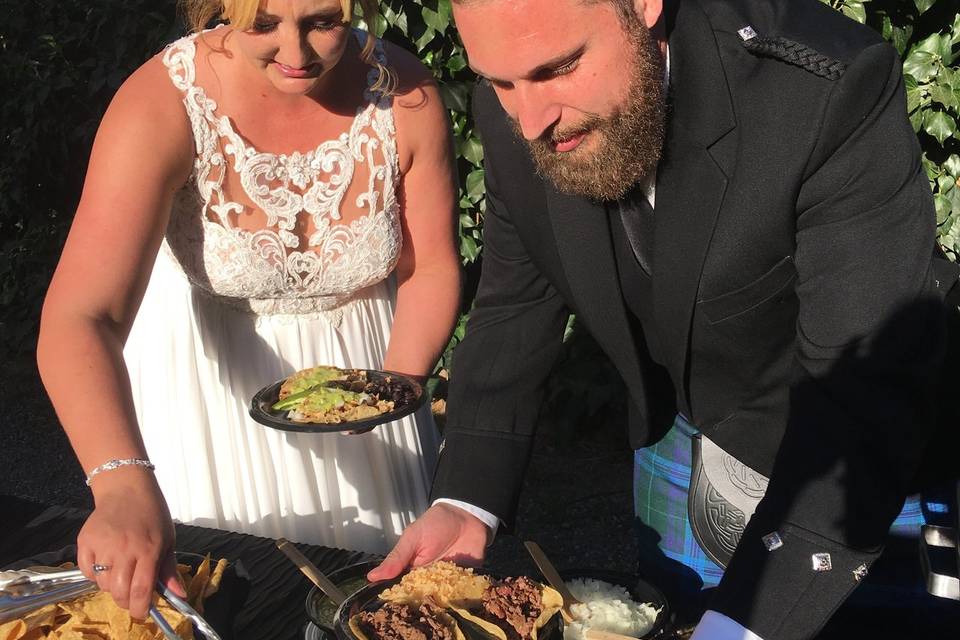 Bride and groom preparing tacos