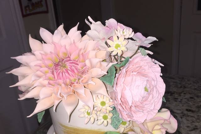A small wedding cake and handmade sugar flowers
