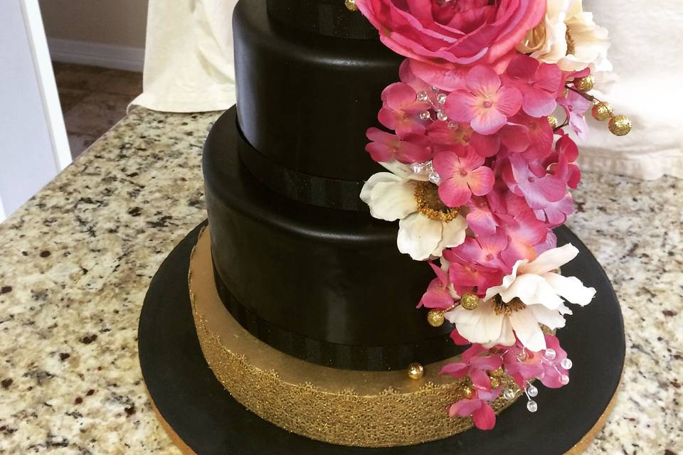 Black and Gold Wedding cake with silk flowers