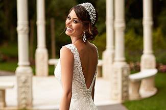 This Stella York wedding dress is made from vintage-inspired corded Lace on soft Tulle over Lavish Satin. The back zipper is concealed under sparkling crystal buttons. Inspired by the world’s hottest trends, Stella York bridal gowns are handcrafted with romantic details that stand the test of time.