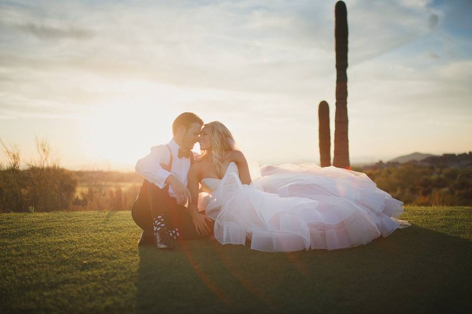 The couple sit om the manicured lawn