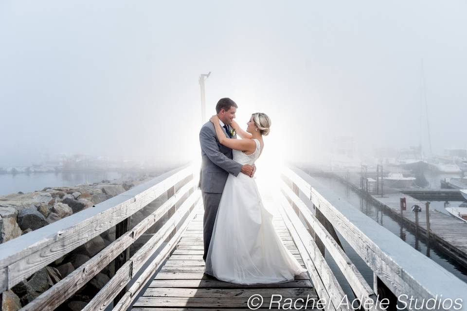 Couple embrace on a dock