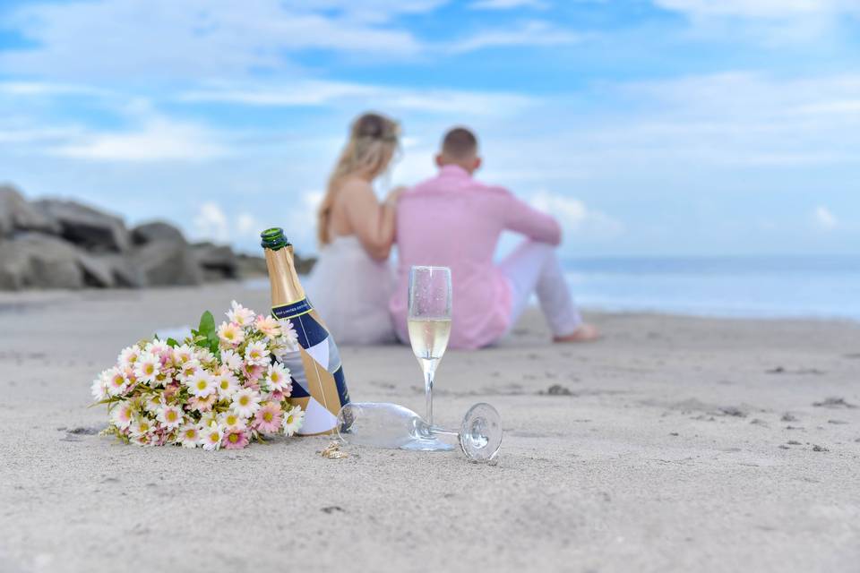 Couple and champagne on the beach