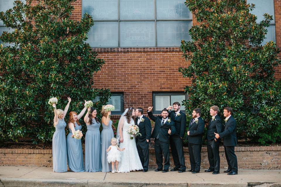 The couple with their groomsmen and bridesmaids