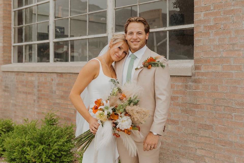 Bride and groom posing out fro