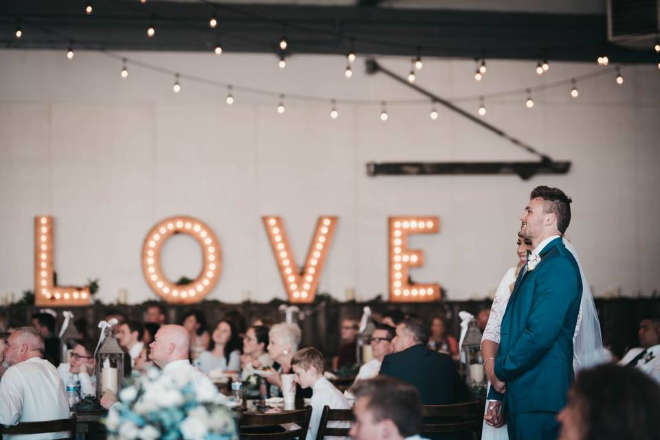 Bride and groom with Love Sign