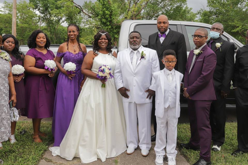 Family posing with the newlyweds