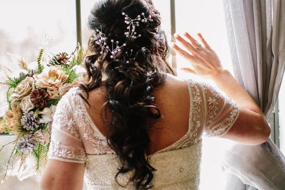 Curled hair decorated with baby's breath flowers