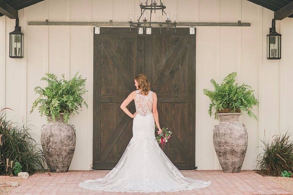 Bride by the wedding barn