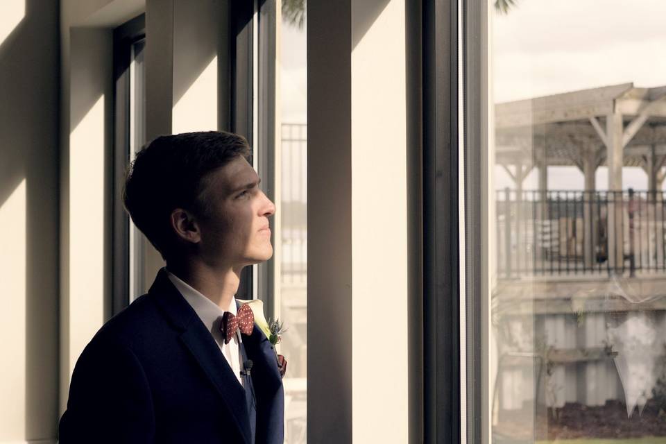 Groom gazes out the window