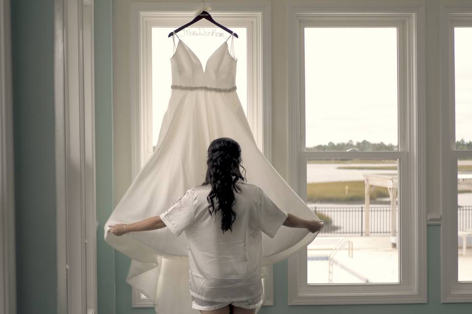 Bride admires her dress
