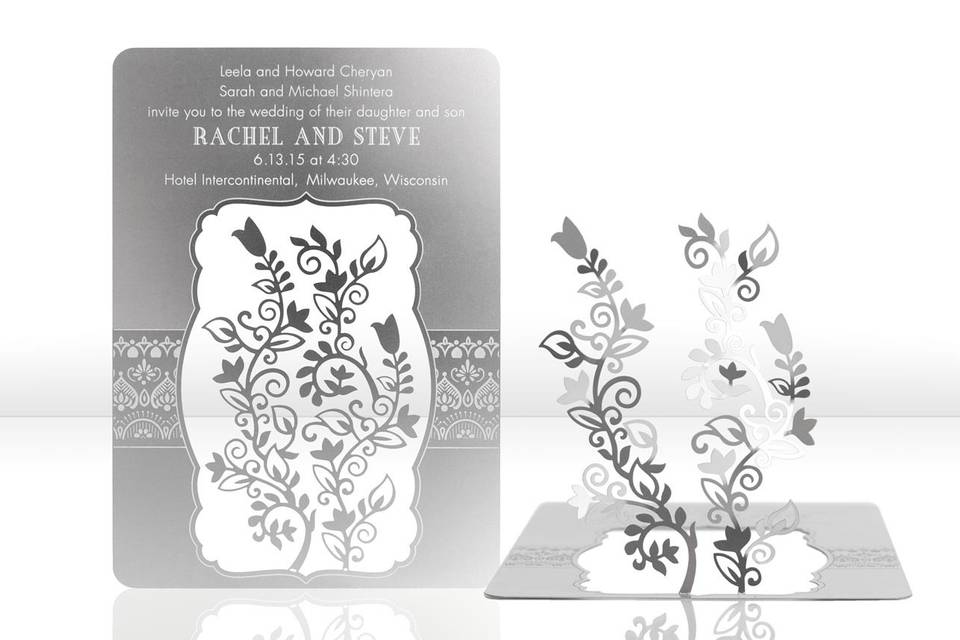 In the HENNA metal invitation, floral vines with an Indian flare will astonish your friends and family! Mails flat and is folded into a sculpture by guests. Folding the invitation at the perforations will allow the vines to stand and be sculpted. Place a tea light behind the sculpture for beautiful, dancing shadows. Or use as home décor. HENNA is also available as a favor with slits into which an escort card can be inserted.