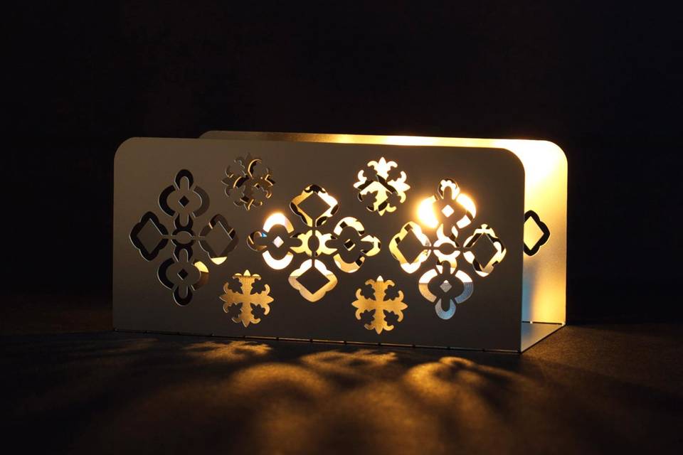 The ORNATE metal invitation sets the mood for a festive and exotic celebration. Mails flat and is folded into a sculpture by guests. Folding the invitation at the perforations will create a 2-sided box. A tea light inside will set the design aglow, sparking memories of a spectacular day for years to come. ORNATE is also available as a favor with slits into which an escort card can be inserted.