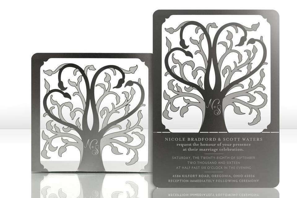 The ROOTS metal invitation… roots are a symbol of where you came from and foundation for where you’re headed. Two hearts in the branches symbolize your union. Mails flat and is folded into a sculpture by guests. Folding the invitation at the perforations will allow the tree to stand and the branches to be sculpted – each sculpture will be as unique as your guests. Place a tea light behind the sculpture for beautiful, dancing shadows. Or use as home décor. ROOTS is also available as a favor with slits into which an escort card can be inserted.