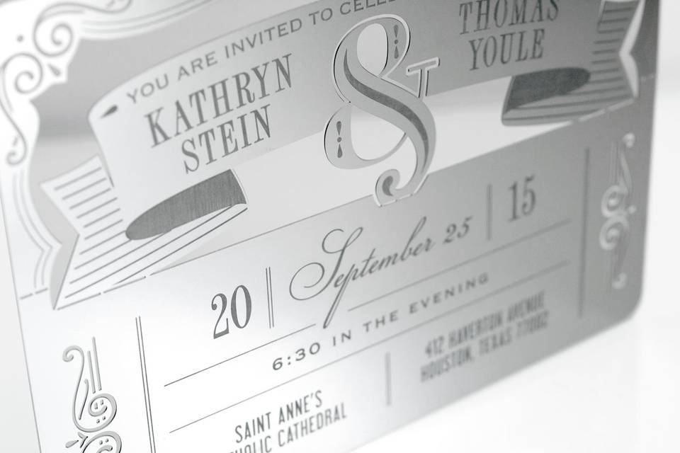 The AMPERSAND metal invitation combines formal and fun with typography that will knock their socks off! Mails flat and is folded by guests to form a sculpture. Folding at the perforations reveals 3 layers of depth, with the ampersand in front, the banner behind, and the frame in the background. AMPERSAND is also available as a favor, with slits into which an escort card can be inserted.
