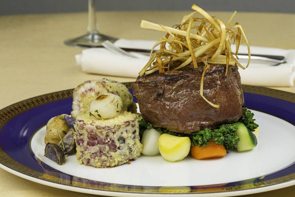 Grilled filet mignon with mexican corn, roasted rosemary peruvian and golden potatoes, deep fried leek hay, parisienne vegetables and broccoli rabe