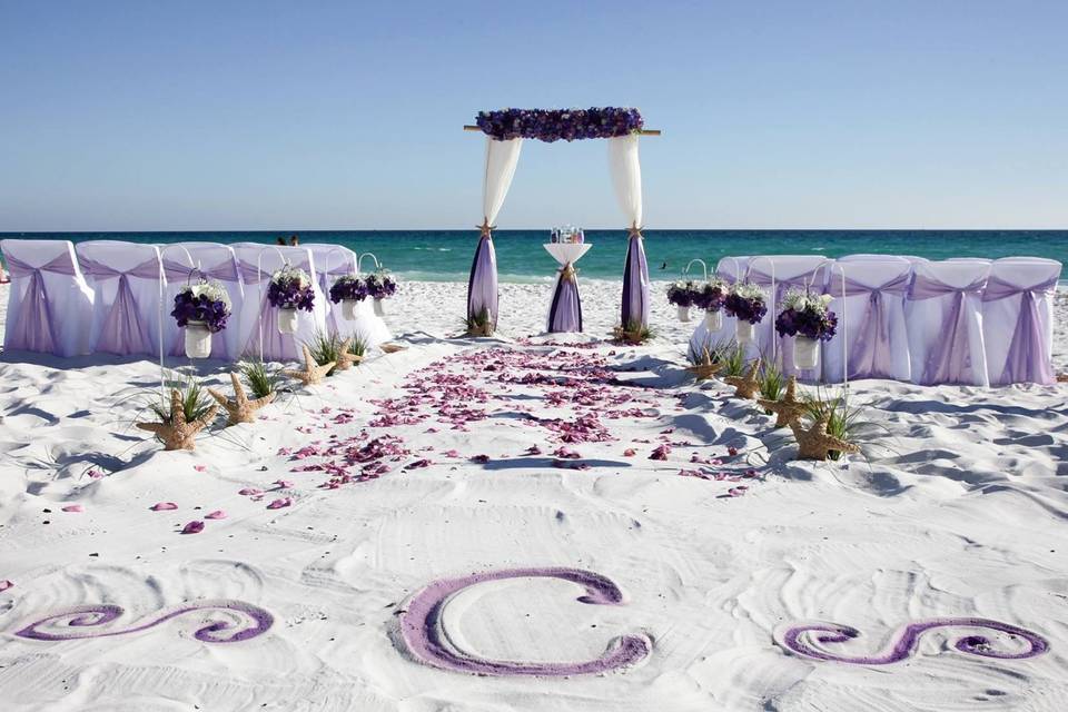 Barefoot Weddings colored monogram in the sand