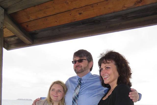Happy couple with officiant