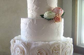 Wedding cake with white roses at the bottom