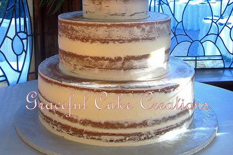 Naked wedding cake with flowers on top