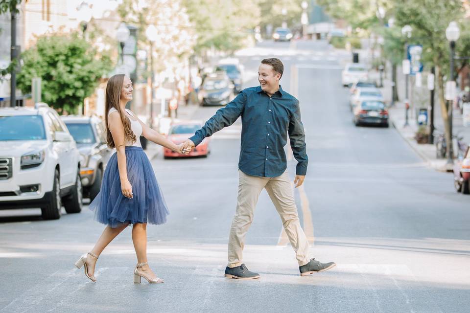 Engaged couple cross road