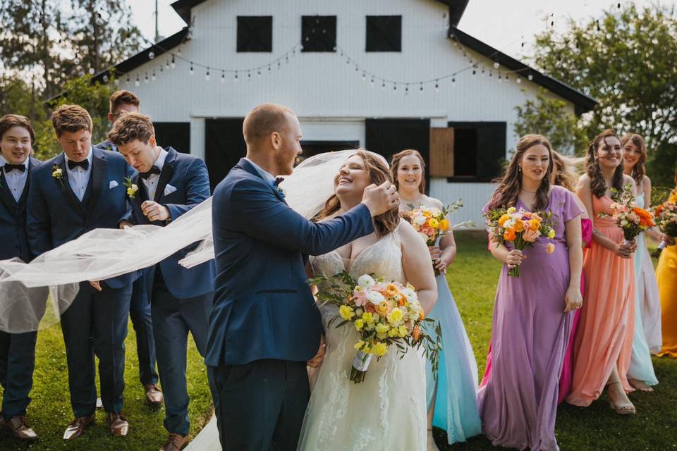 Bridal party in front of barn
